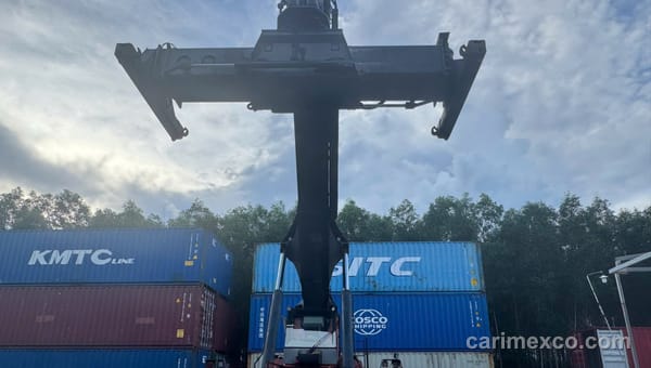 A container handler working a KMTC Line container at the Nhon Trach yard
